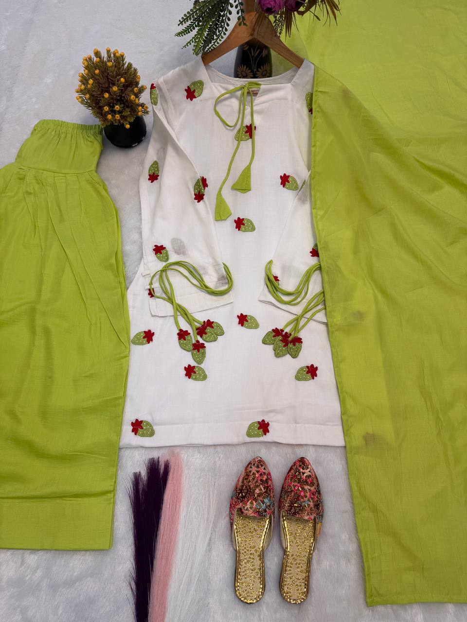 Ethereal Ivory White Short Kurti Adorned with Delicate Floral Embroidery and Tassel Detailing, Paired with a Vibrant Mehendi Green Salwar
